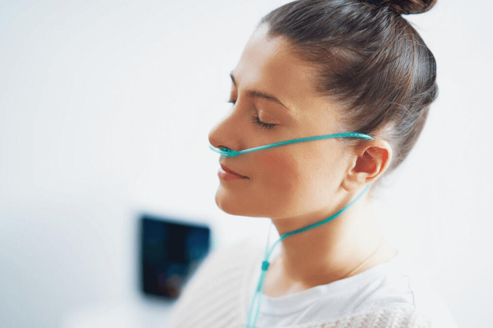Person relaxing and using a nasal cannula for a wellness session